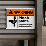 Pinch point safety signage for roller doors, conveyors, and machinery.